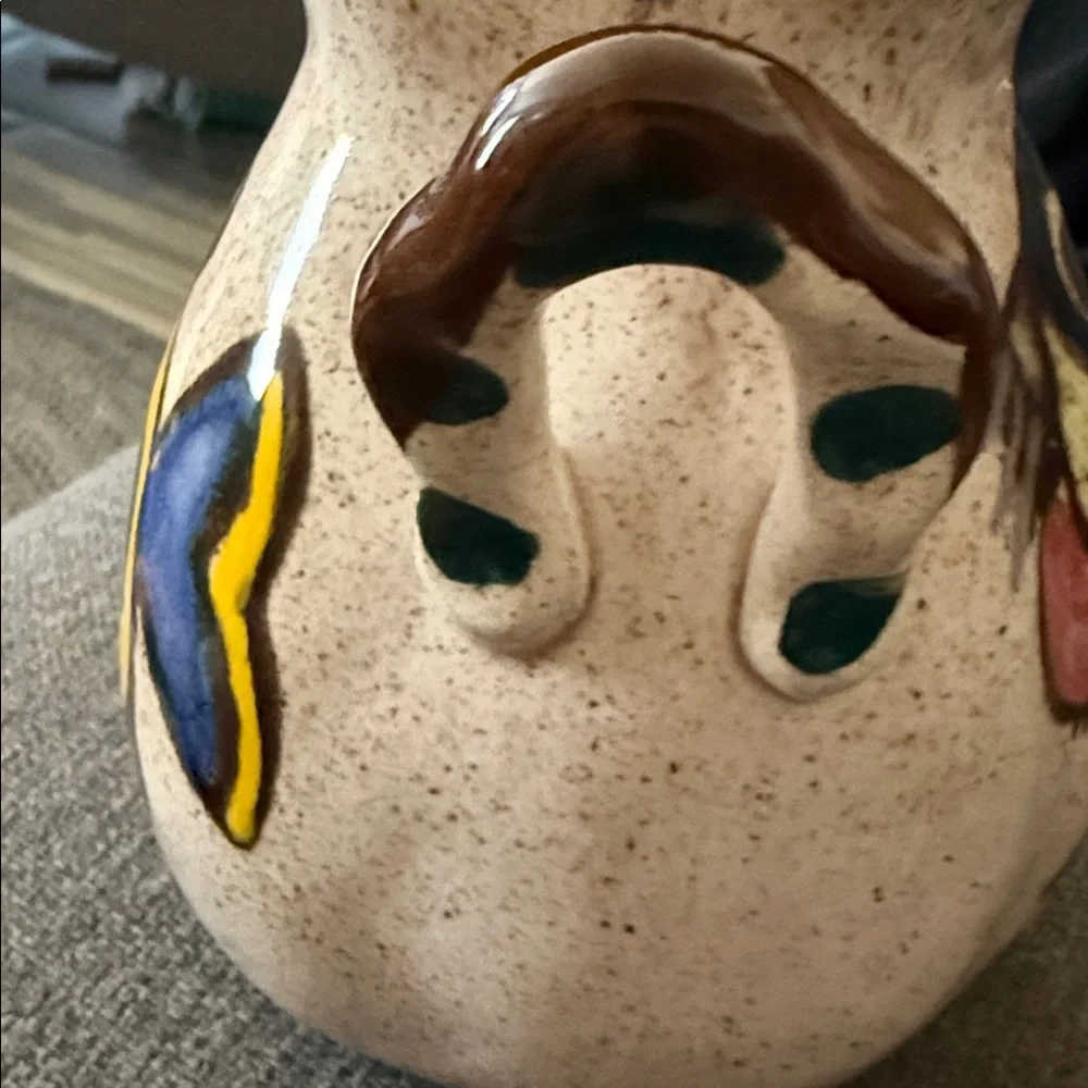 This is a vintage hand-painted ceramic pitcher 1976
